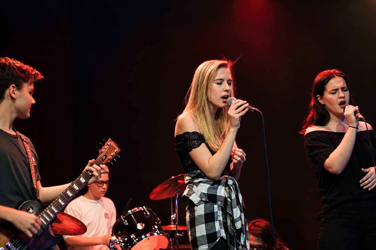 MBMS band performing with two singers, guitarist and drummer