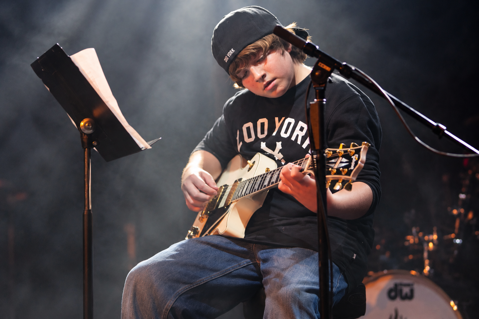 Electric guitarist under stage lights · MBMS archive
