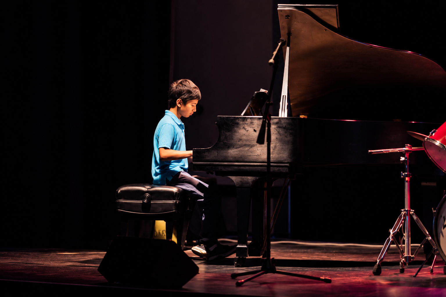 Pianist on a darkened stage · MBMS archive