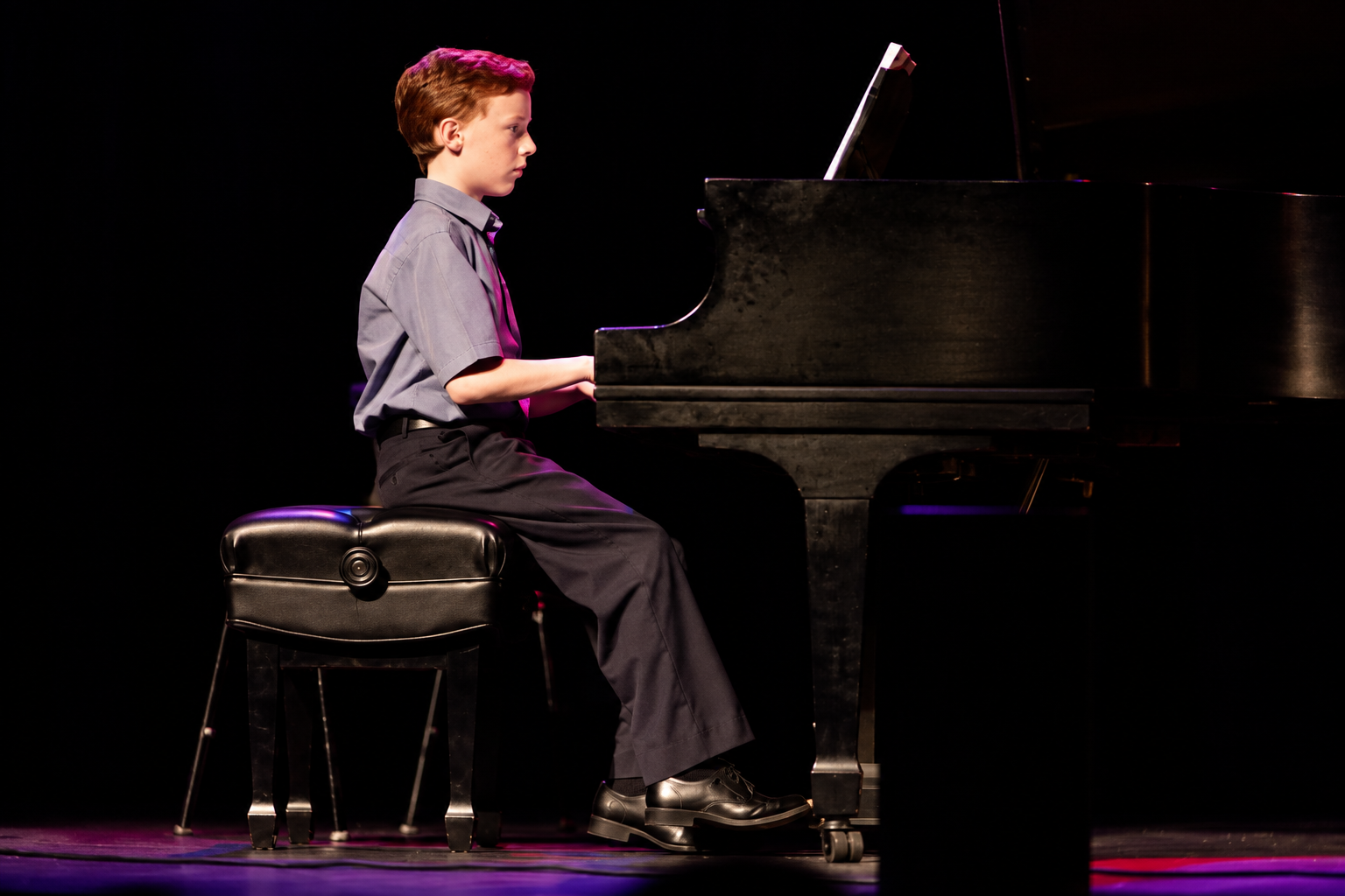 Pianist on a darkened stage · MBMS archive