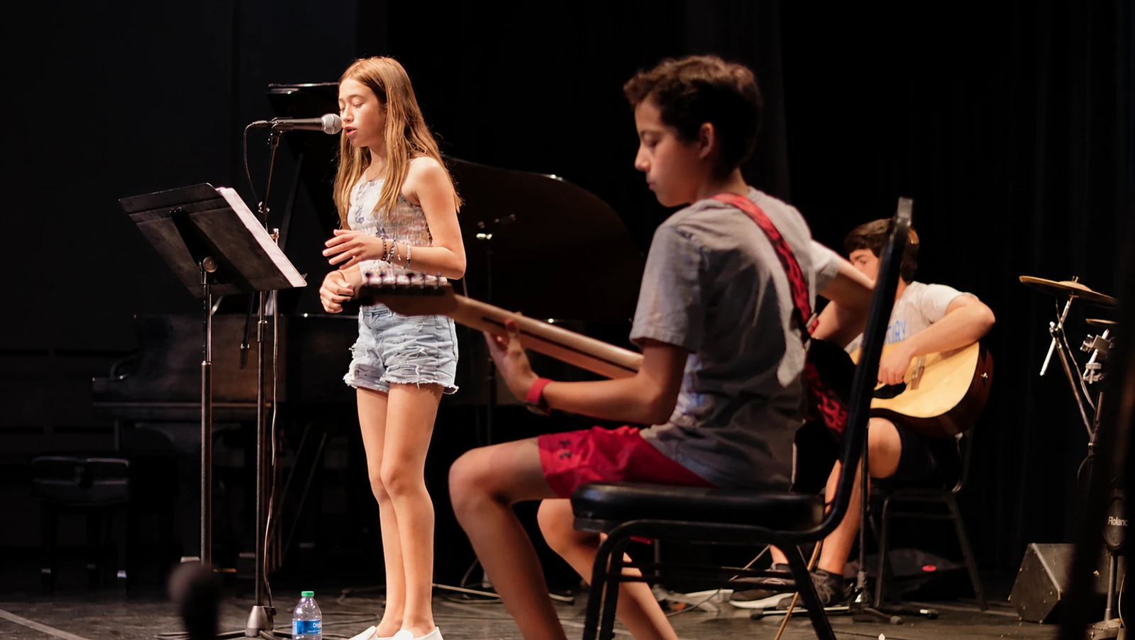 Young musicians singing and playing guitars together